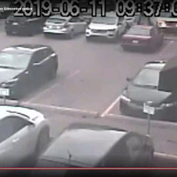A compilation of two security camera recordings of the incident and zoomed-in scenes from the bystander video shows a white pickup truck trying to evade the police vehicles boxing it in by backing into one and driving forward into another, before it stops. Officers converge on the scene; one officer kicks the driver-side door of the truck into the driver and hits him in the head with a weapon held in his hand. Officers can be seen kicking Parkhurst, then shoving his head into a brick wall. A handcuffed Parkhurst and a bald police officer come into view as the officer walks him towards a police vehicle; the officer slams him up against the vehicle. A group of officers is later seen gathered beside a police vehicle; they appear to be re-enacting their actions in the arrest.